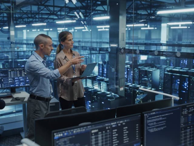 Close-up of a data center server rack with cables and indicator lights