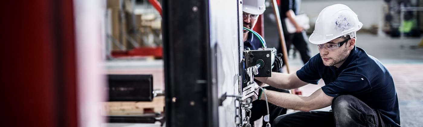 Element building products testing engineer examining a door in a testing frame