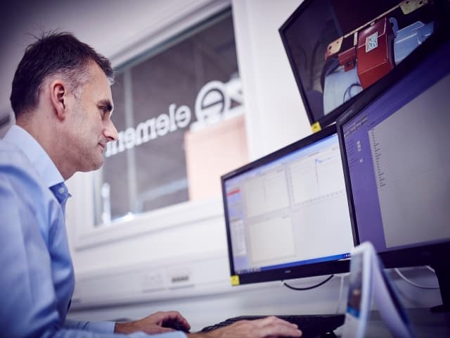 Element testing professionals collaborating on certification services and quality assurance protocols