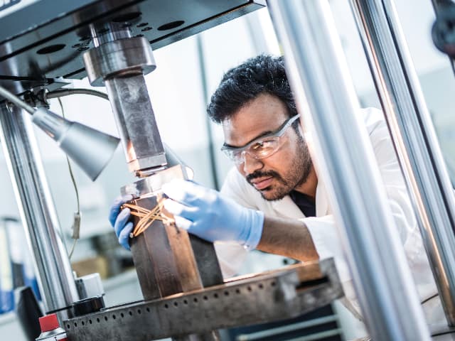 Element materials scientist conducting precision testing with advanced laboratory instrumentation
