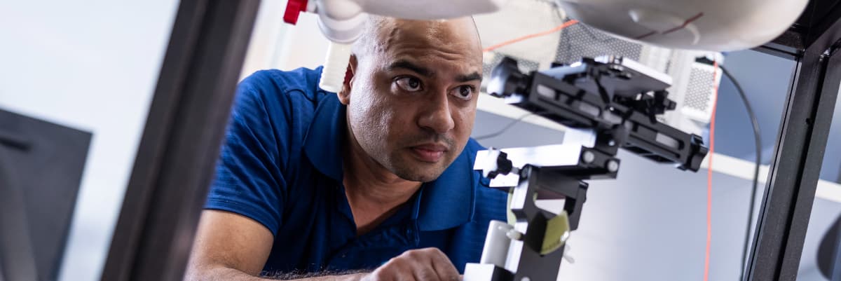 Element materials testing engineer operating precision measurement equipment for quality analysis