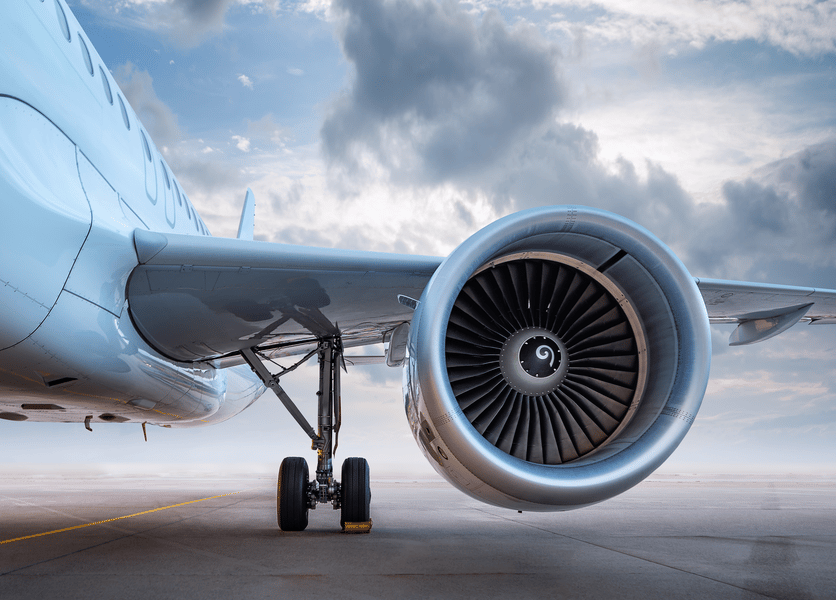 Close up of engine turbines of stationary airplane on a tarmac